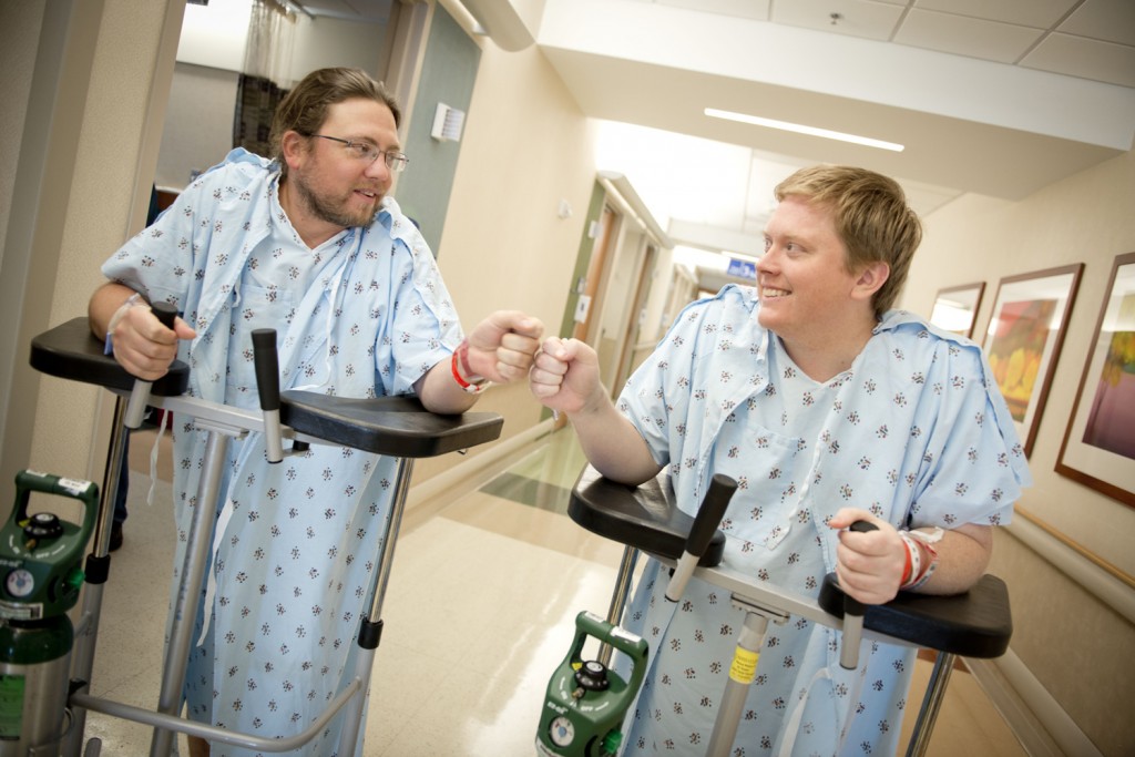 Adam Gray (left), kidney donor, shares a fist bump with his cousin and kidney transplant recipient Trey Sullivan.
