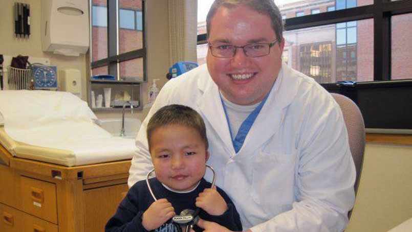 Dr. Brandon Phillips with a young patient. 