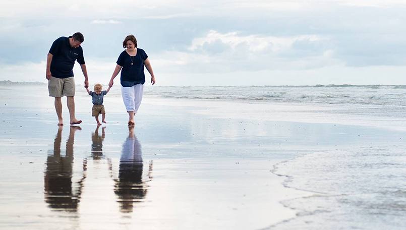 Collin Markum, shown walking on the beach with his family, was shocked to learn he had a rare cardiac condition that required open-heart surgery. Now after successful surgery and rehabilitation, Collin is working to help fund research and promote heart health.